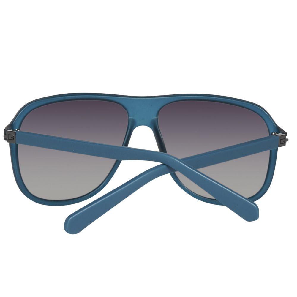 Lunettes de soleil Guess bleues en plastique, verres dégradés gris-bleu.