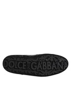 Semelle extérieure noire de sneakers Dolce & Gabbana, logo gravé DOLCE & GABBANA et motifs décoratifs.